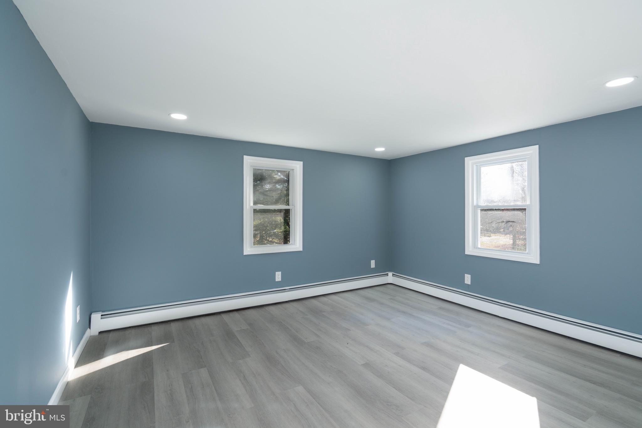 960 Carmel Road Millville, NJ 08332 - Photo 16 of 35 an empty room with wooden floor and windows
