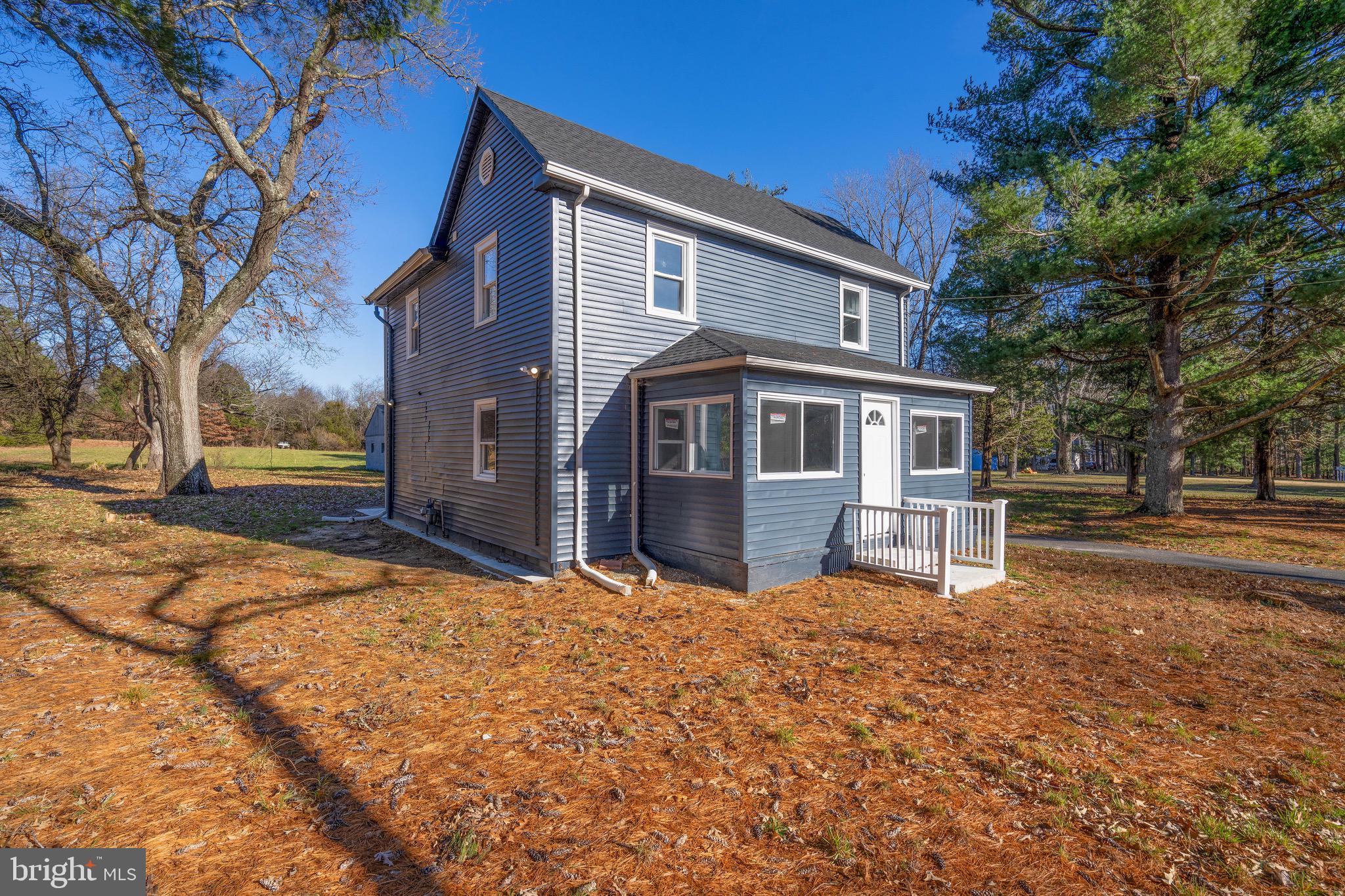 960 Carmel Road Millville, NJ 08332 - Photo 3 of 35 a front view of a house with a yard covered with snow and trees
