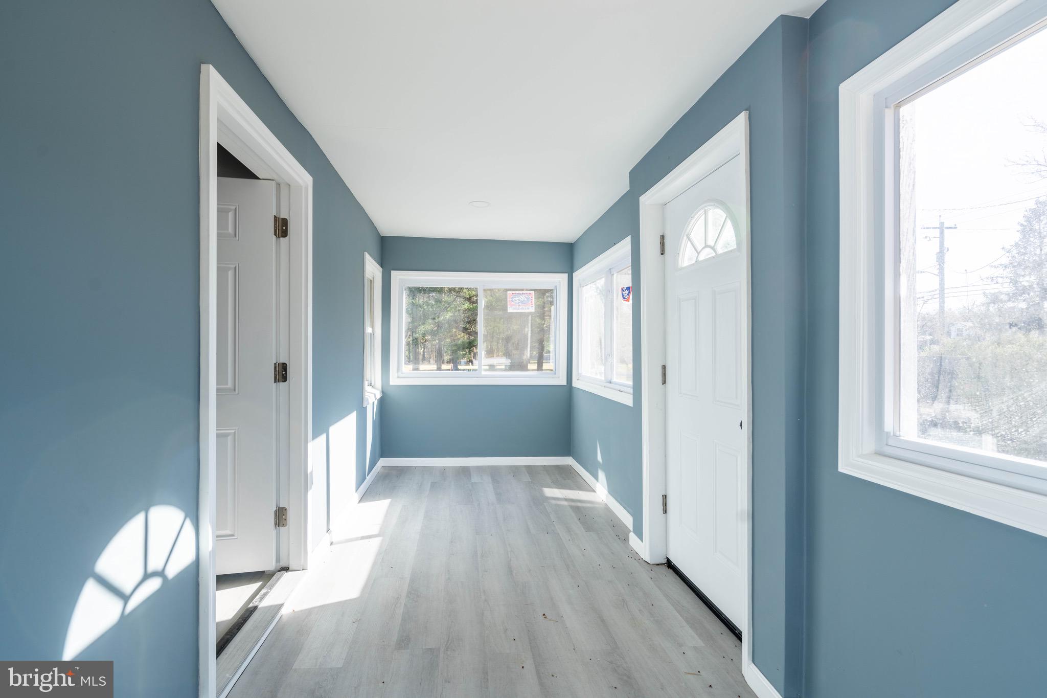960 Carmel Road Millville, NJ 08332 - Photo 4 of 35 a view of a hallway with wooden floor and windows
