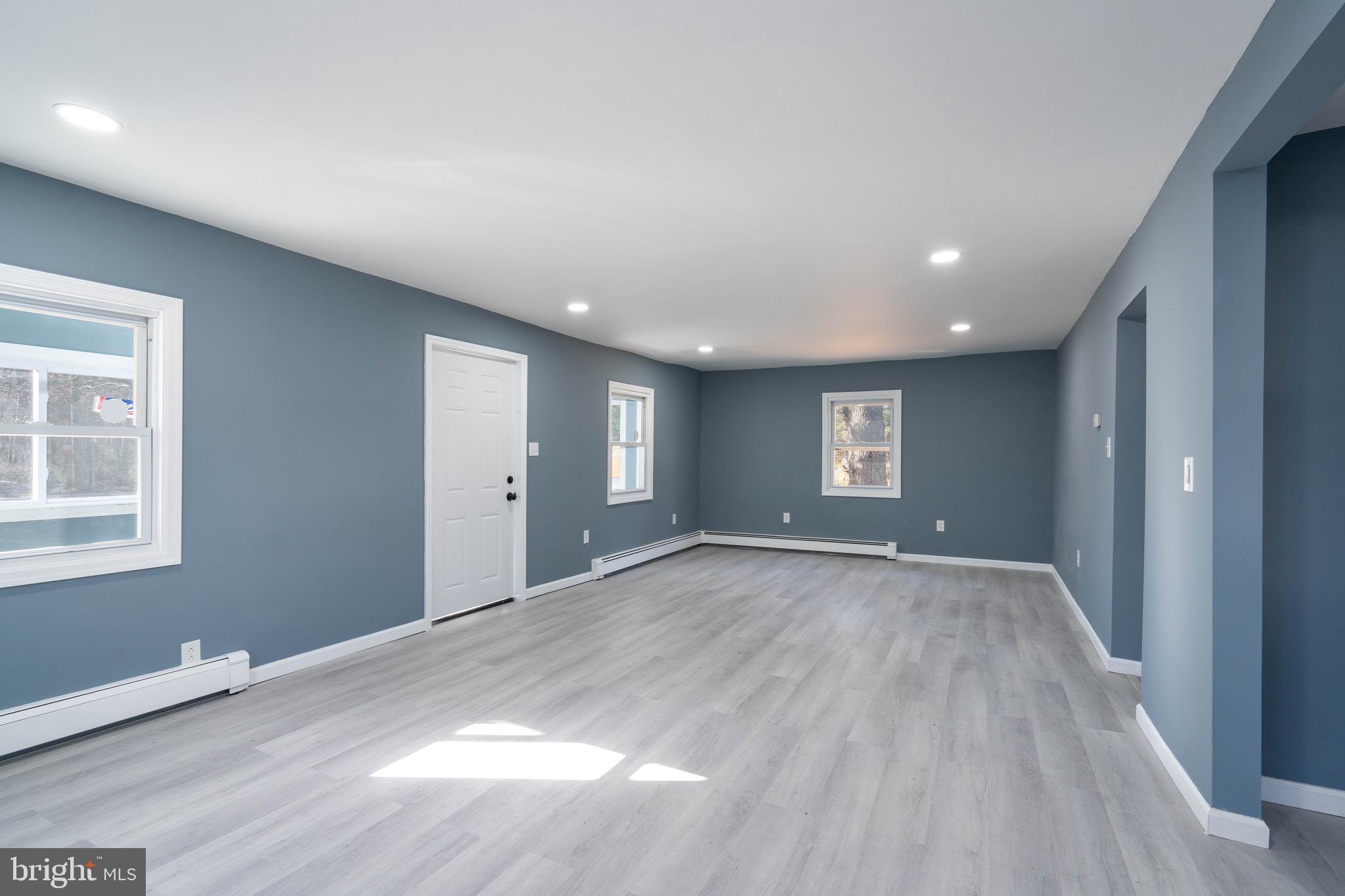 960 Carmel Road Millville, NJ 08332 - Photo 5 of 35 an empty room with wooden floor and windows