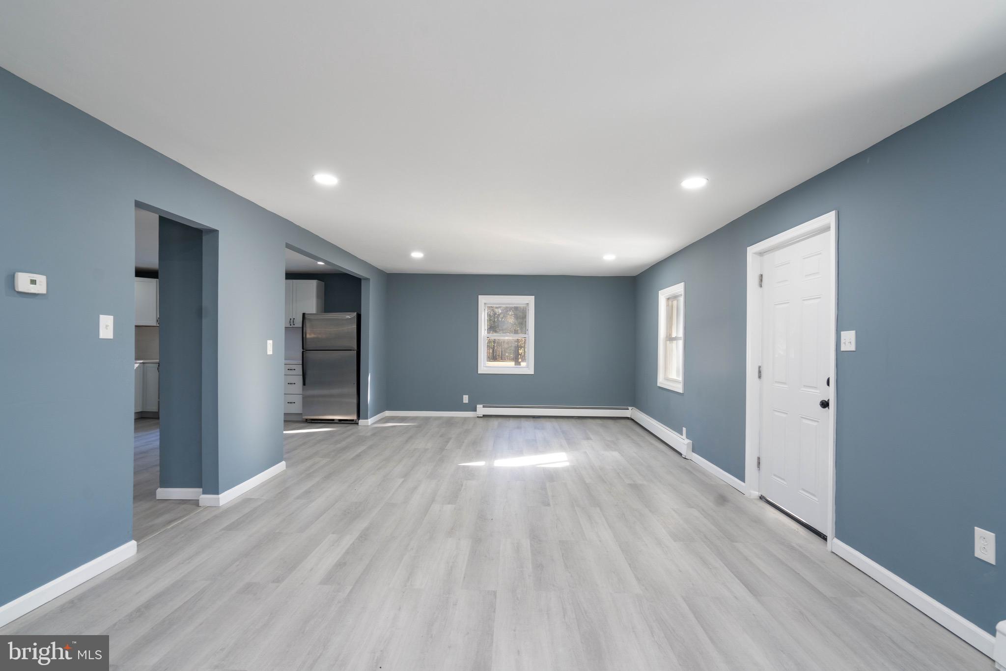 960 Carmel Road Millville, NJ 08332 - Photo 6 of 35 an empty room with wooden floor and windows