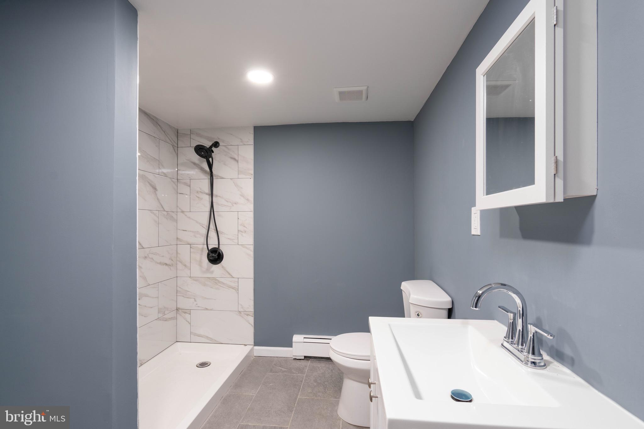 960 Carmel Road Millville, NJ 08332 - Photo 10 of 35 a bathroom with a sink toilet and shower