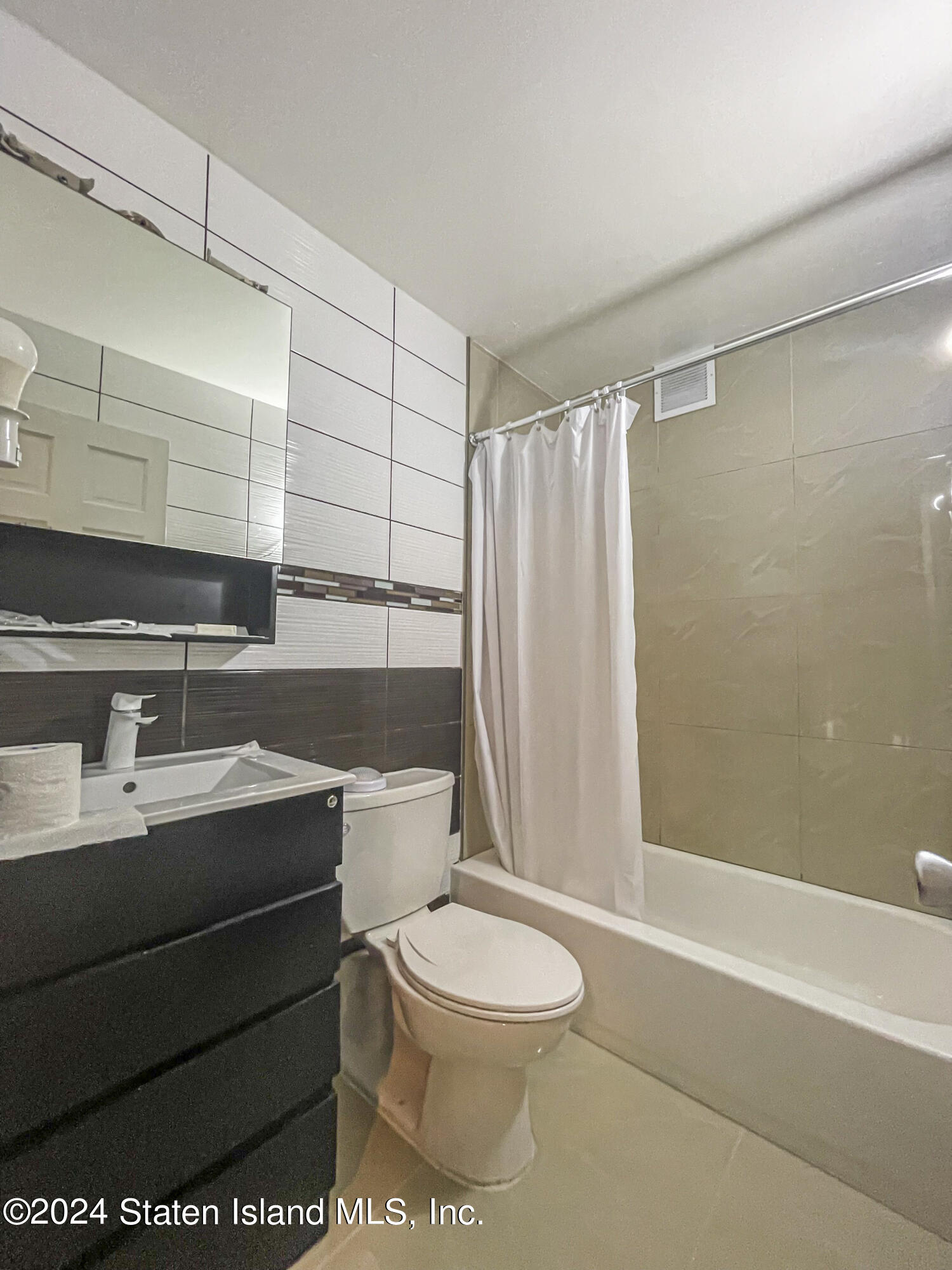 175 Zoe Street, Unit 5S Staten Island, NY 10305 - Photo 14 of 15 a bathroom with a sink a toilet and shower