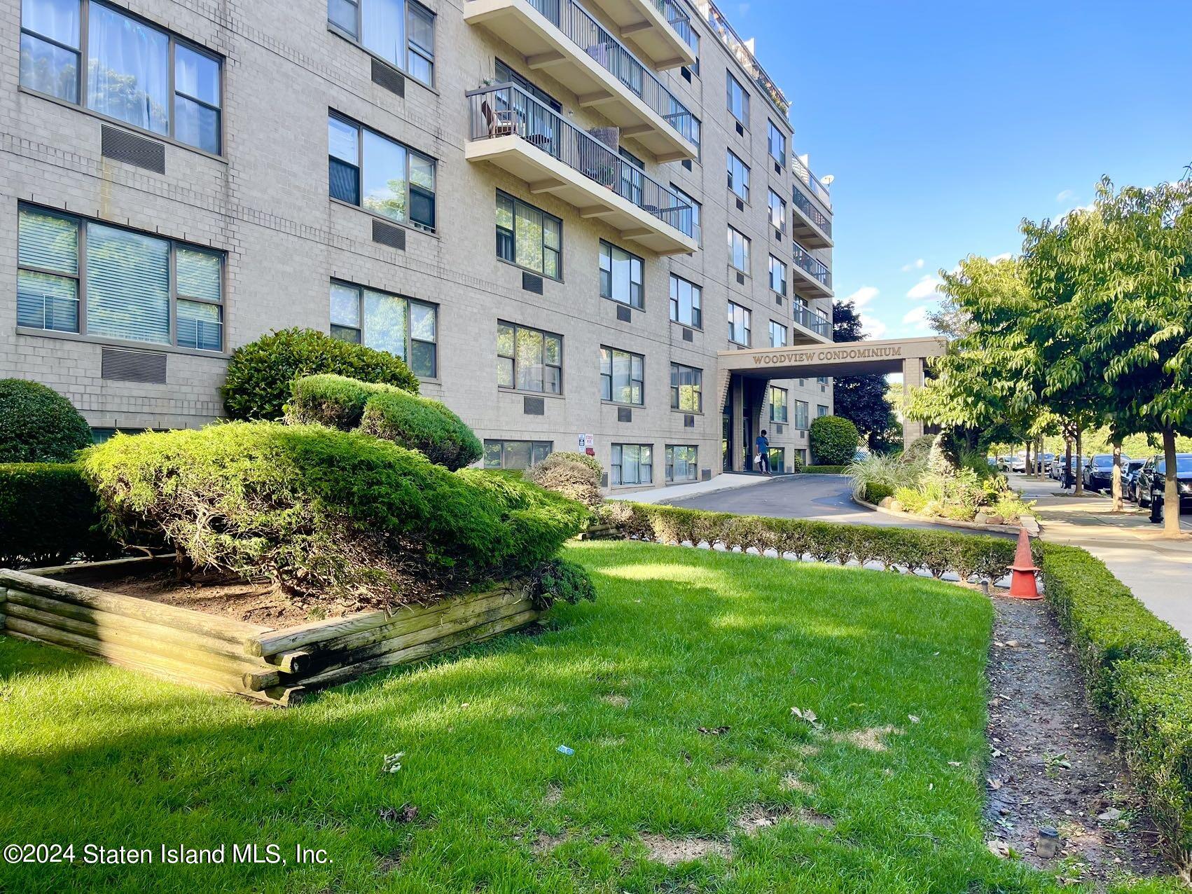 175 Zoe Street, Unit 5S Staten Island, NY 10305 - Photo 3 of 15 a garden with trees in front of it