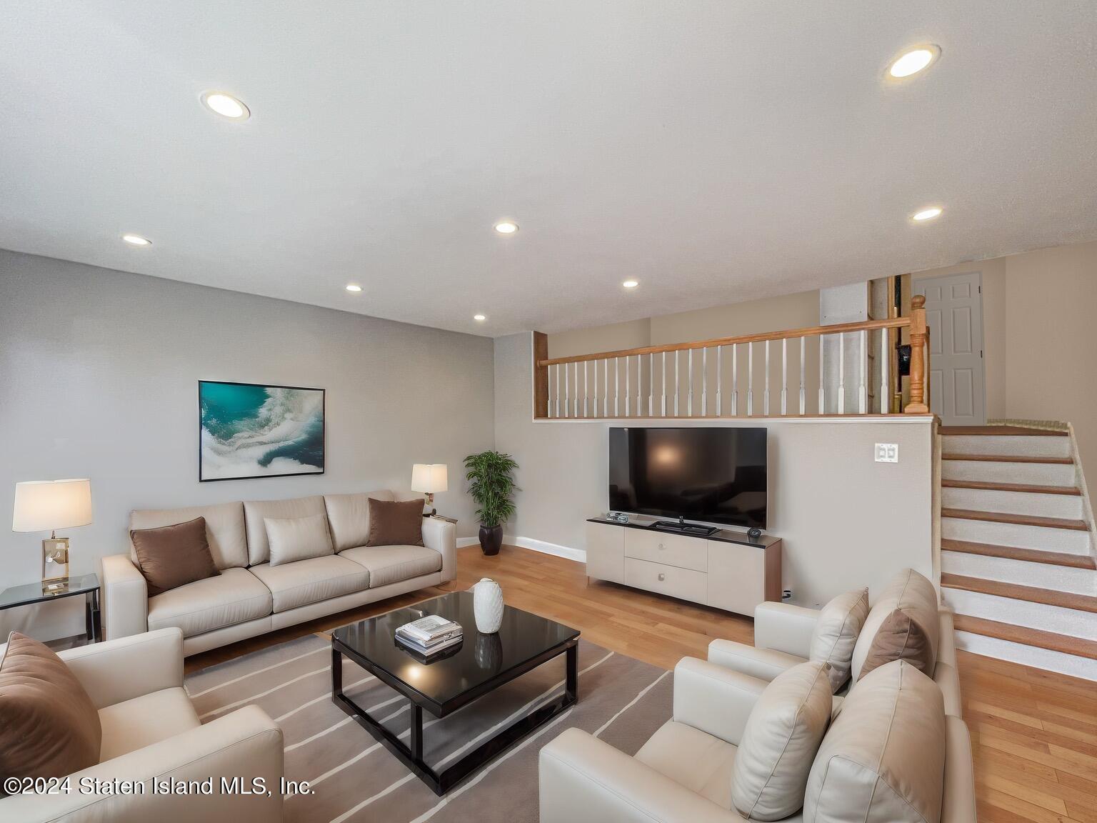 175 Zoe Street, Unit 5S Staten Island, NY 10305 - Photo 9 of 15 a living room with furniture and a flat screen tv