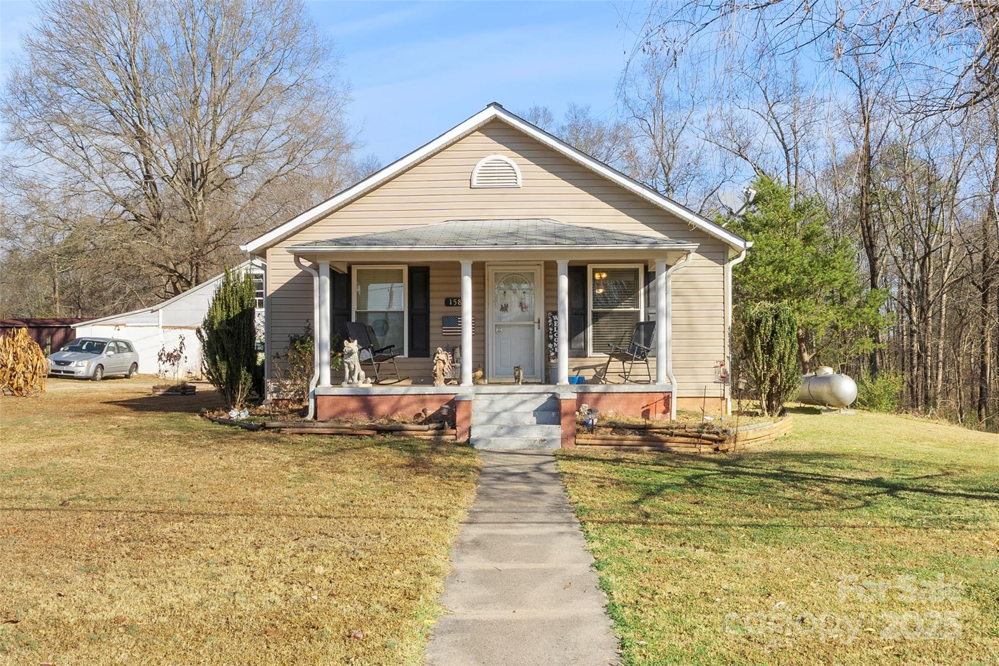 1580 Pine Ridge Road China Grove, NC 28023 - Photo 2 of 35 a view of a white house with swimming pool and sitting area