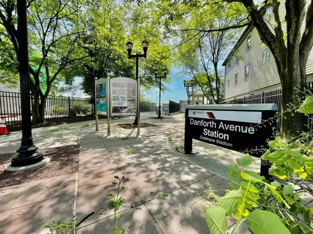 a view of a street with a tree
