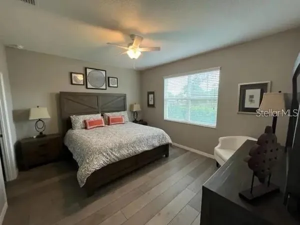 a bedroom with a bed and a chandelier