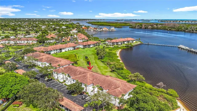 an aerial view of a house with a garden and lake view