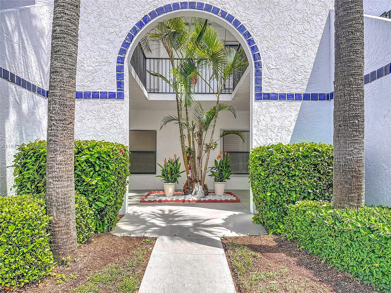 6082 Southeast Landing Way, Unit 11 Stuart, FL 34997 - Photo 22 of 57 a front view of a house with garden