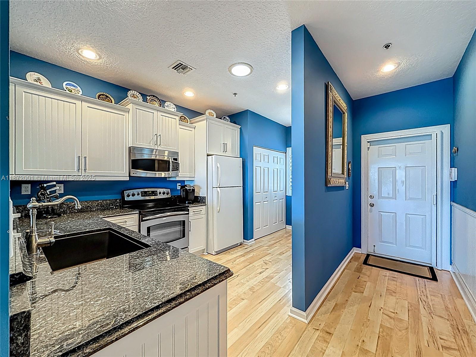 6082 Southeast Landing Way, Unit 11 Stuart, FL 34997 - Photo 24 of 57 a kitchen with stainless steel appliances granite countertop a sink stove and refrigerator