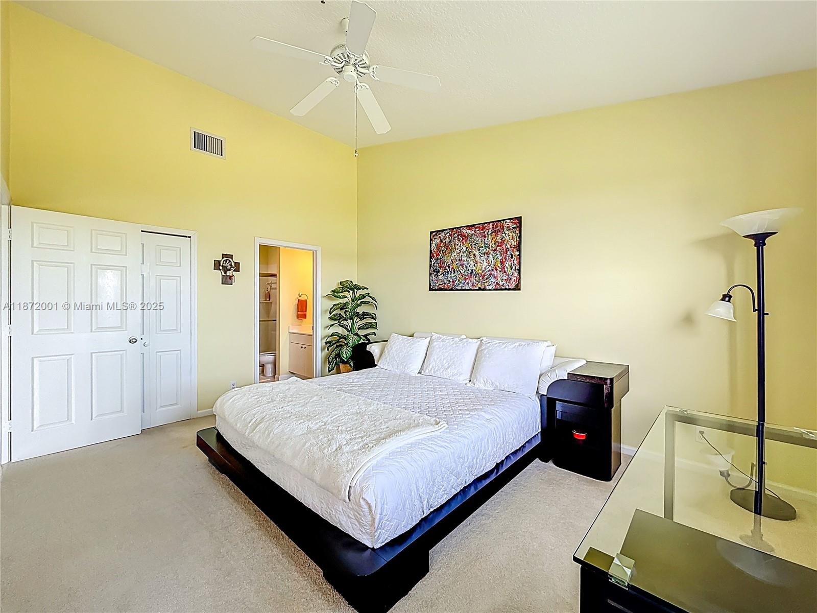 6082 Southeast Landing Way, Unit 11 Stuart, FL 34997 - Photo 35 of 57 a bedroom with a bed and a table