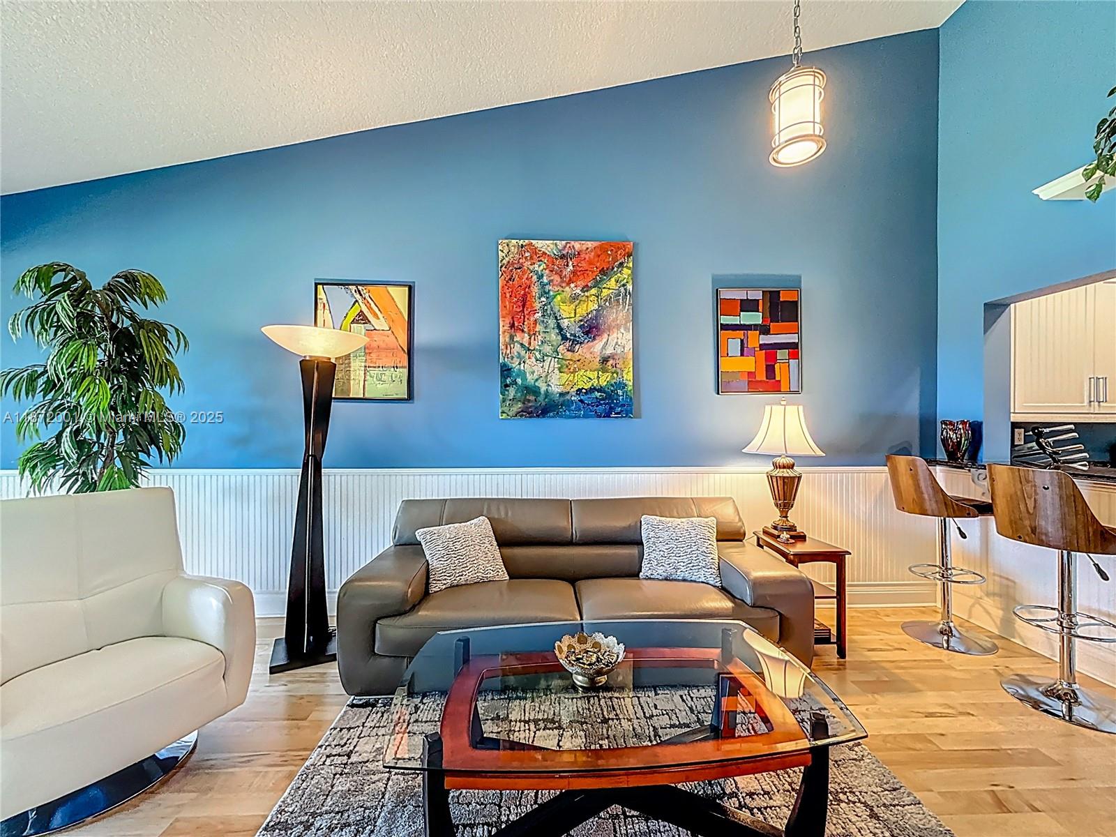 6082 Southeast Landing Way, Unit 11 Stuart, FL 34997 - Photo 41 of 57 a living room with furniture and a potted plant