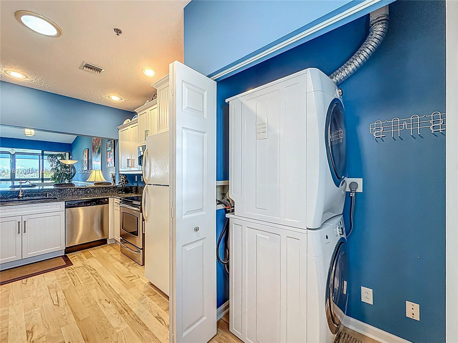 6082 Southeast Landing Way, Unit 11 Stuart, FL 34997 - Photo 46 of 57 a view of a kitchen cabinets and wooden floor