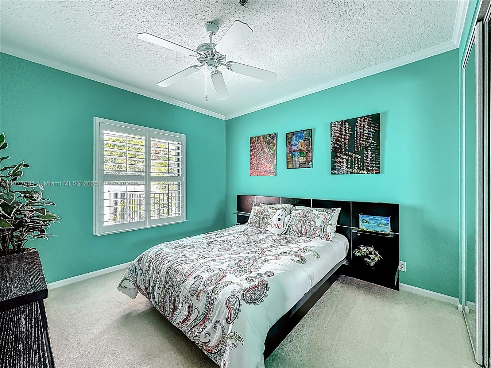 6082 Southeast Landing Way, Unit 11 Stuart, FL 34997 - Photo 53 of 57 a bedroom with a bed and a chandelier