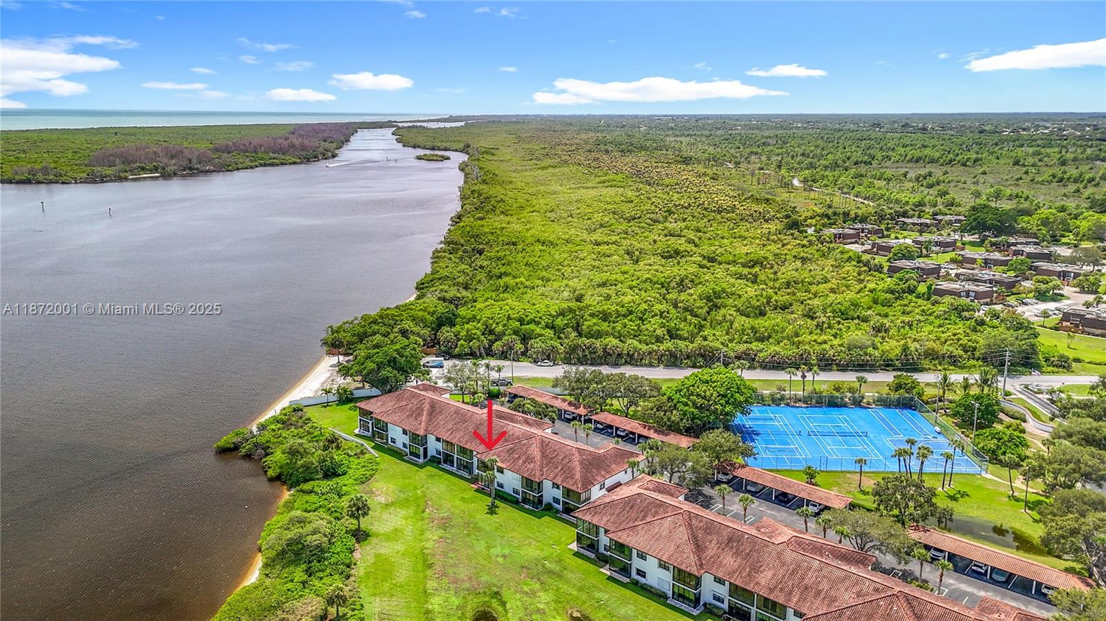 6082 Southeast Landing Way, Unit 11 Stuart, FL 34997 - Photo 8 of 57 a view of an ocean and a yard