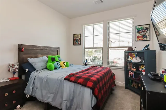 a bedroom with a bed and a desk