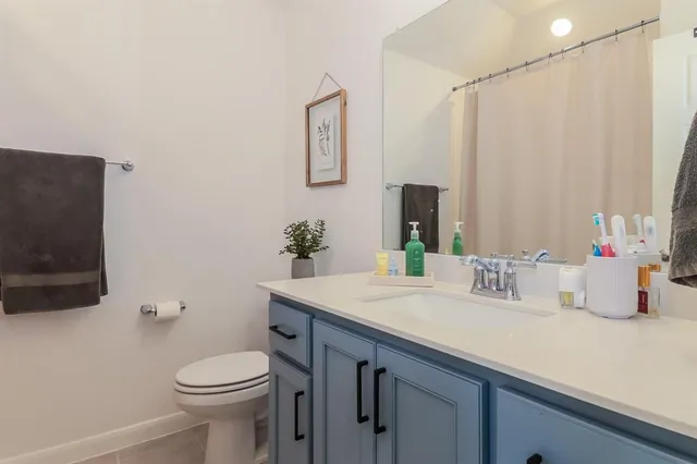 a bathroom with a sink a toilet and mirror