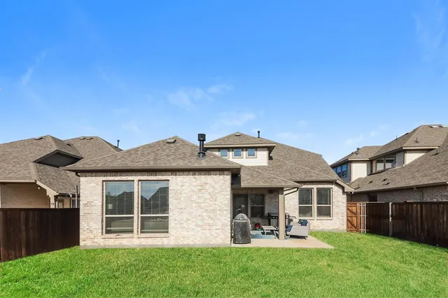 a front view of a house with a garden and plants