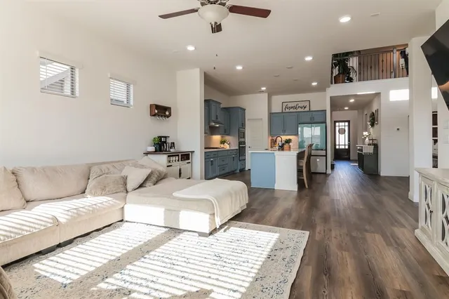 a living room with furniture and a wooden floor