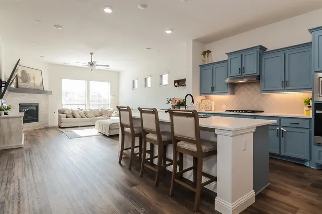 a kitchen with granite countertop white cabinets and stainless steel appliances