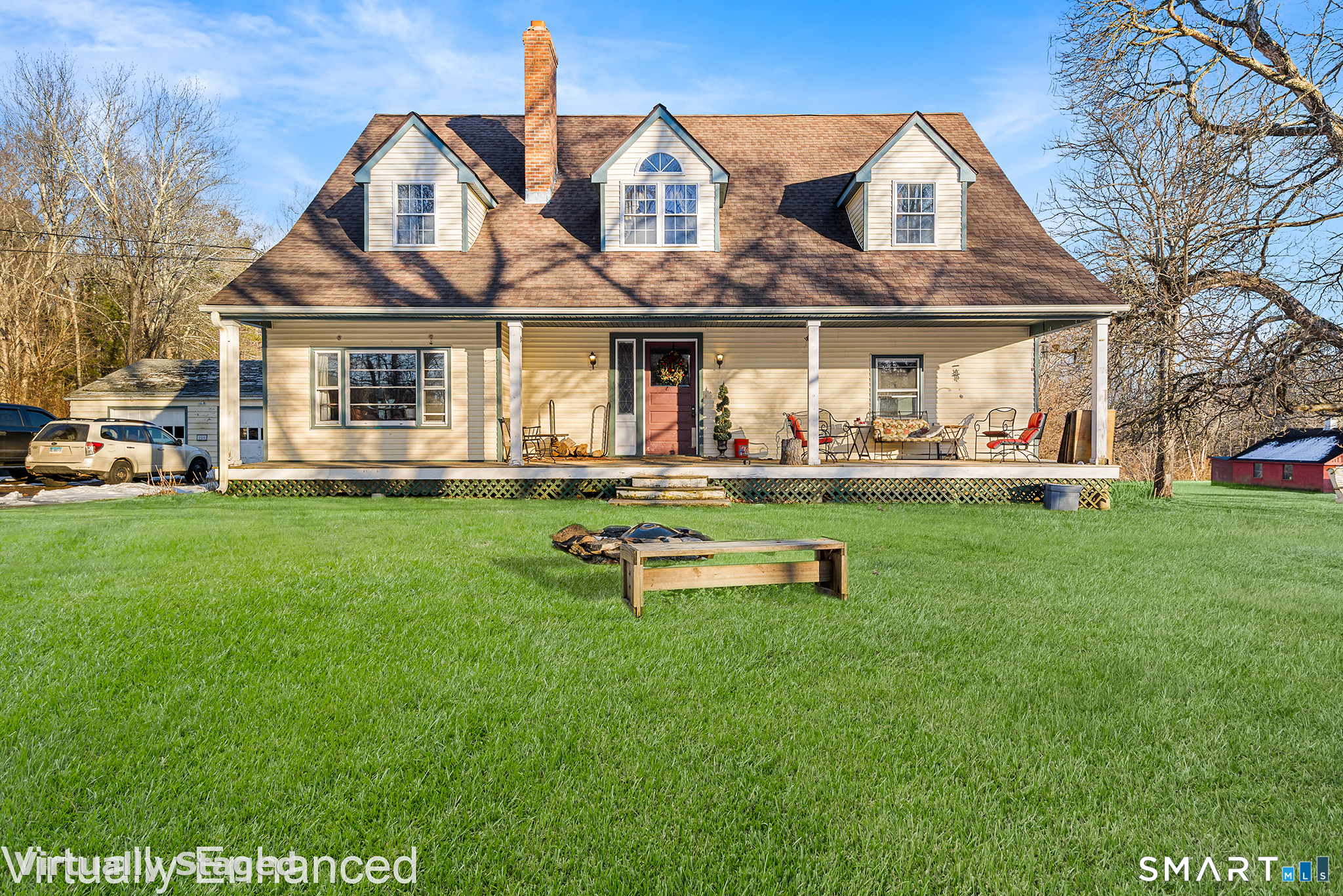 a front view of a house with a yard table and chairs