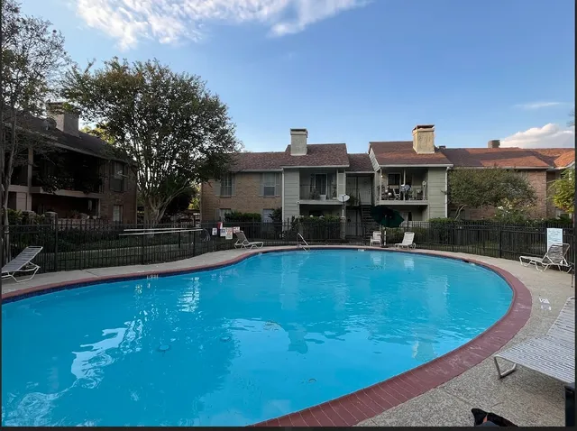 a view of a swimming pool with outdoor seating