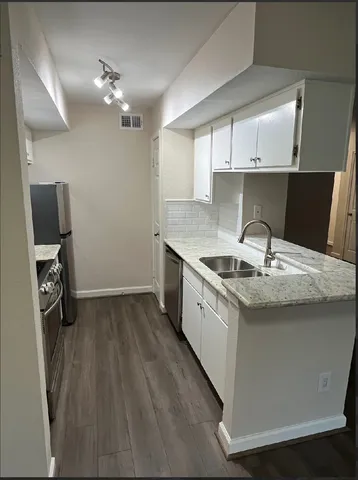 a kitchen with a sink cabinets and window