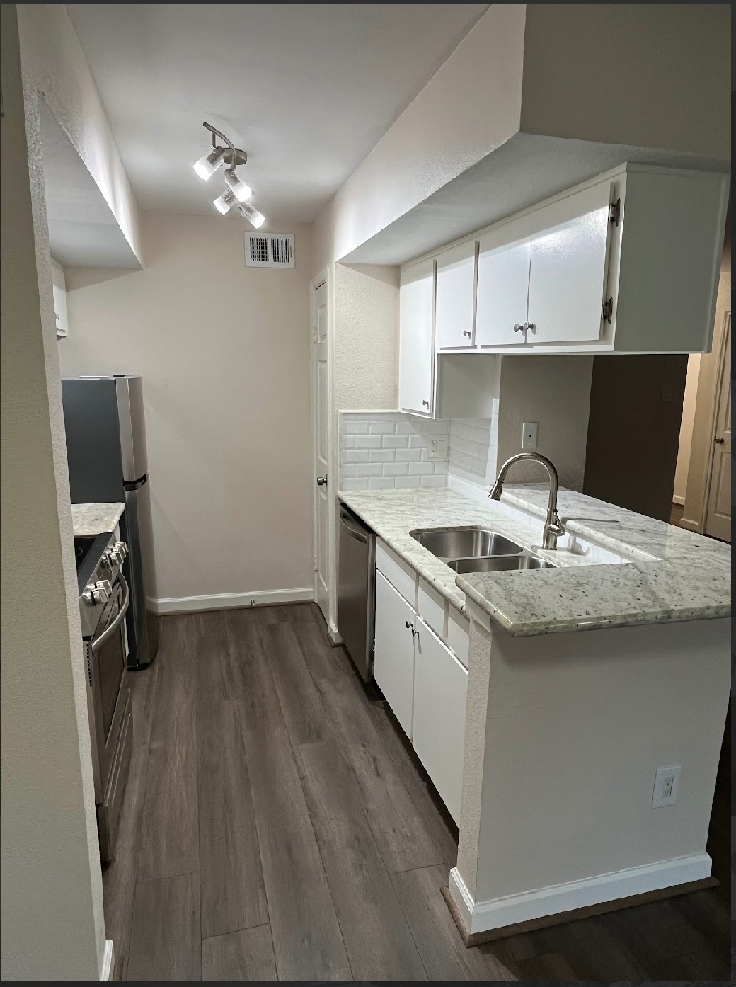 2800 Jeanetta Street, Unit 2706 Houston, TX 77063 - Photo 2 of 19 a kitchen with a sink cabinets and window
