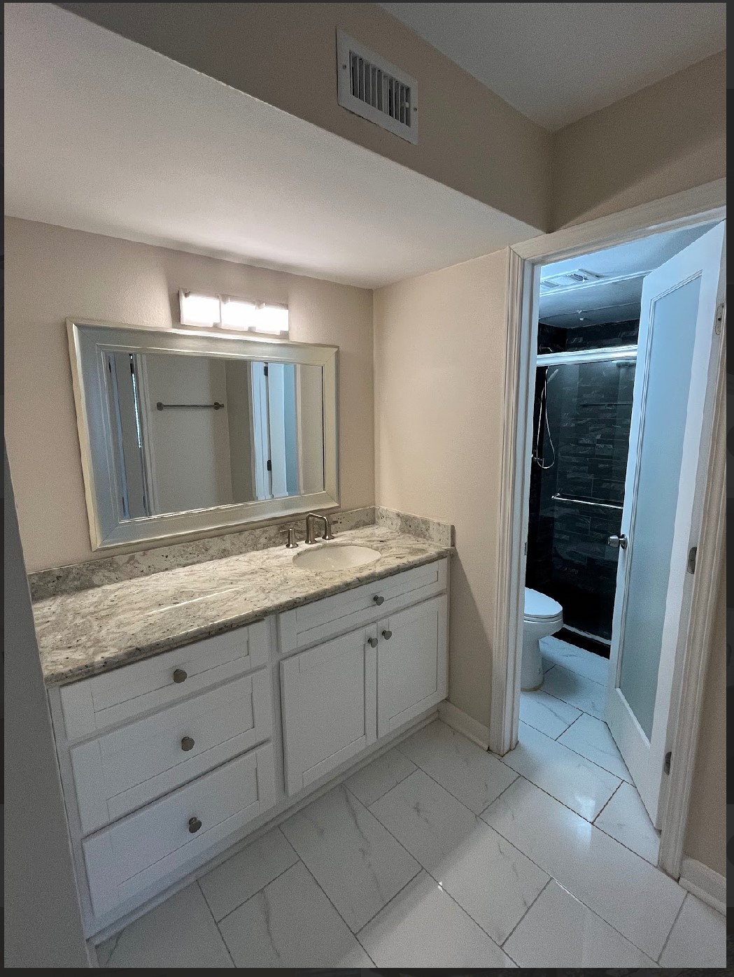 2800 Jeanetta Street, Unit 2706 Houston, TX 77063 - Photo 9 of 19 a bathroom with a granite countertop sink and a mirror