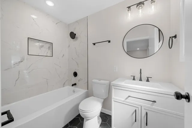 a bathroom with a sink toilet and a bathtub