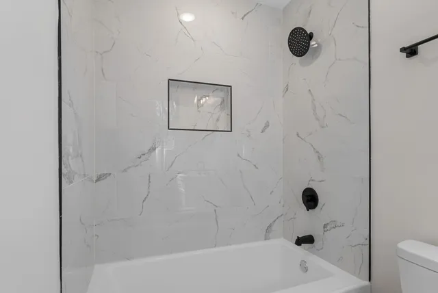 a bathroom with a bathtub and a shower