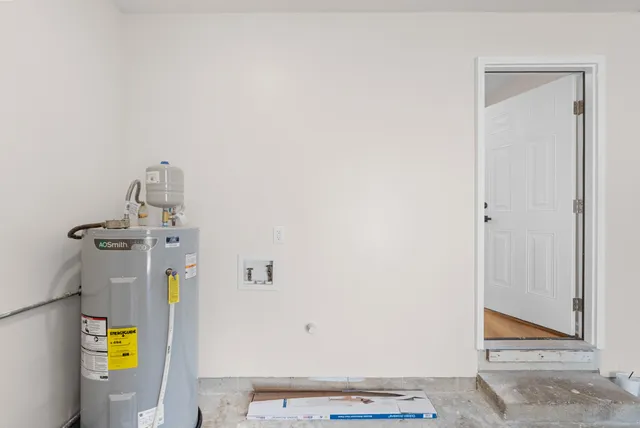 a room with a sink and washing machine