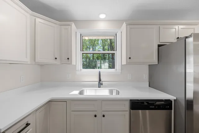 a kitchen with a sink and cabinets