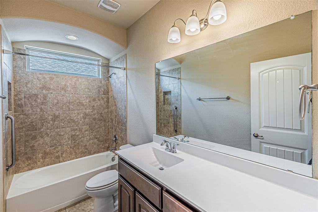 11460 Starlight Ranch Fort Worth, TX 76052 - Photo 19 of 33 a bathroom with a sink a toilet a mirror and shower