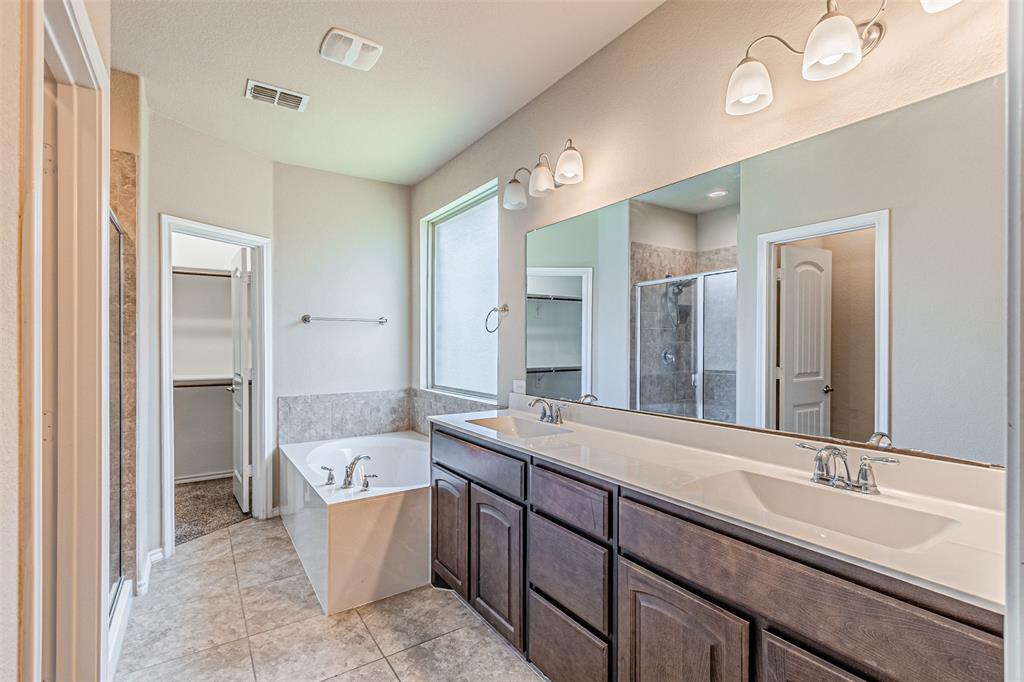11460 Starlight Ranch Fort Worth, TX 76052 - Photo 24 of 33 a bathroom with a tub double sink and mirror