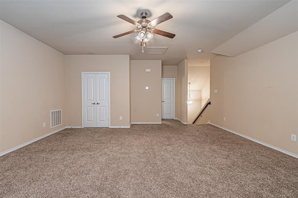 11460 Starlight Ranch Fort Worth, TX 76052 - Photo 28 of 33 a view of an empty room with a ceiling fan