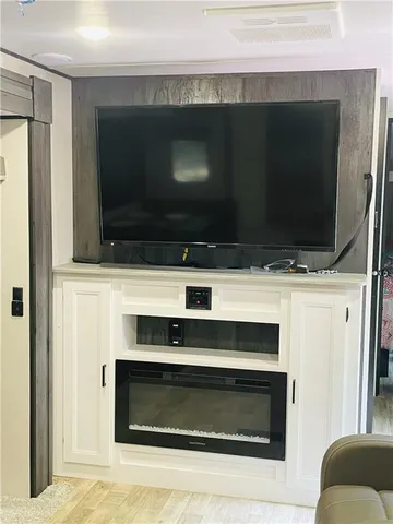 a living room with a fireplace and a flat screen tv