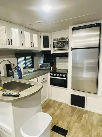 a kitchen with stainless steel appliances granite countertop a sink and cabinets