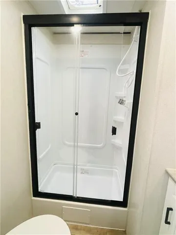 a bathroom with a glass shower door
