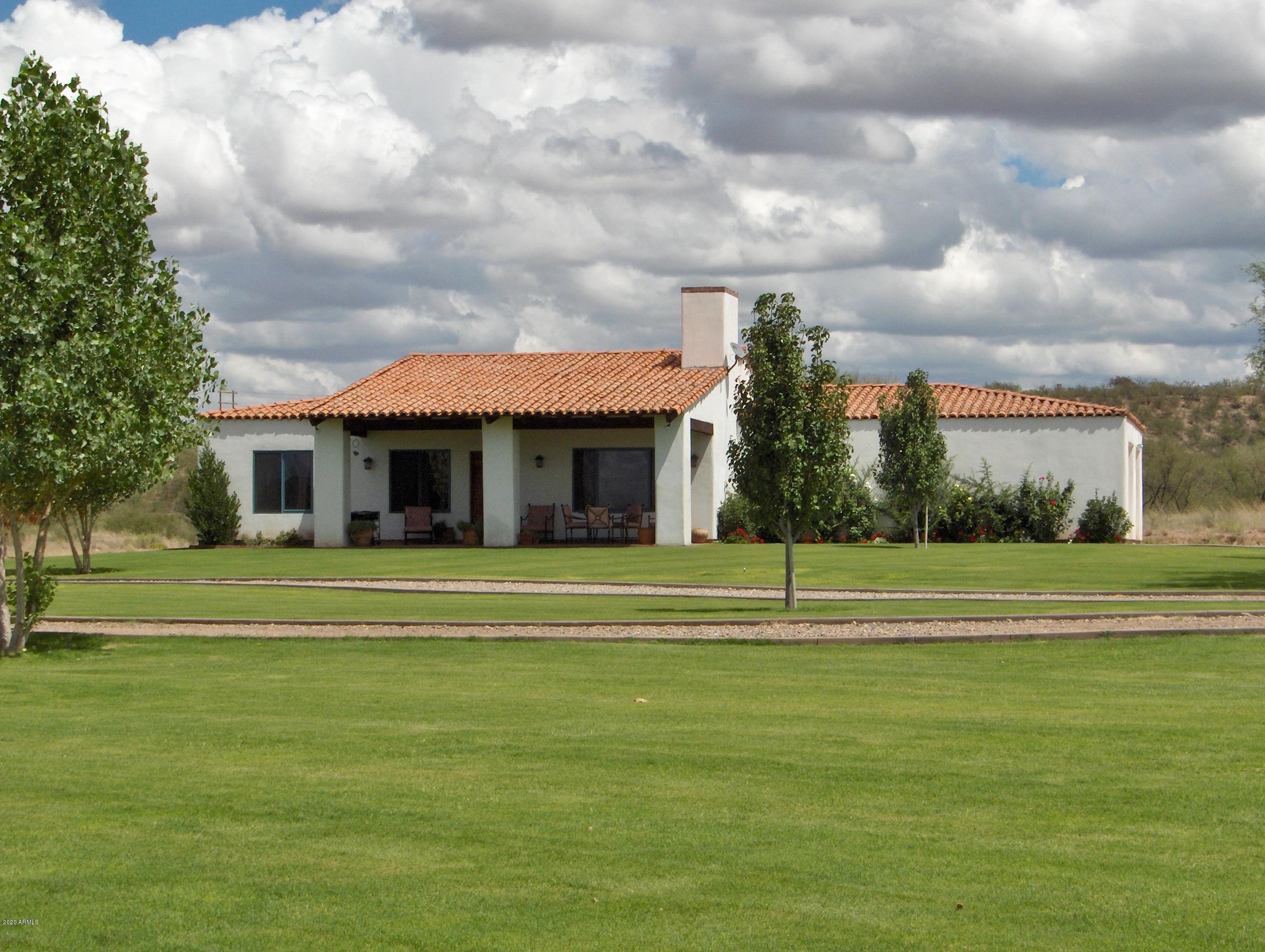 131-2 Amado Montosa Road Amado, AZ 85645 - Photo 10 of 55 a view of a big house with a big yard and large trees