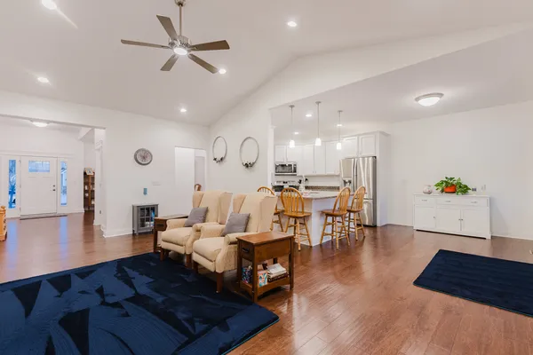 a dining room with furniture and wooden floor
