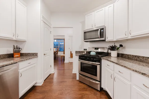 a kitchen with granite countertop a sink and cabinets