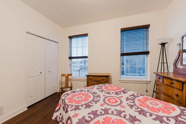 a bathroom with a granite countertop sink a toilet a mirror and bathtub