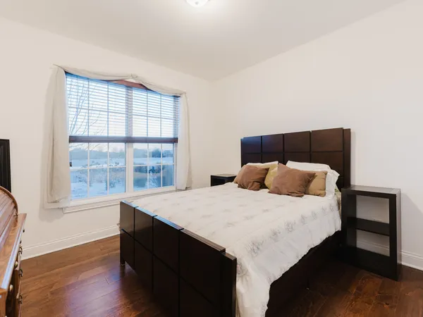 a bedroom with a large bed and a window