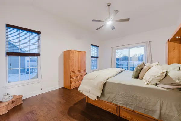 a bedroom with a bed and a chandelier