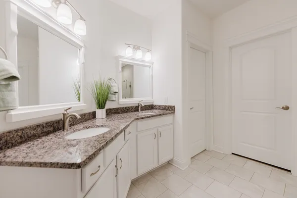 a bathroom with a toilet sink and a mirror