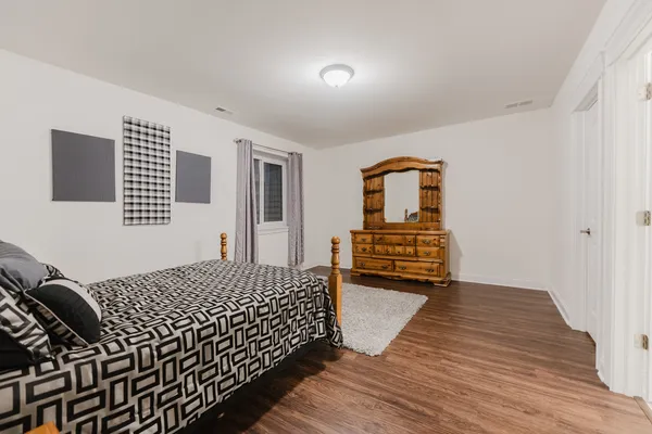a bathroom with a granite countertop sink a toilet and shower