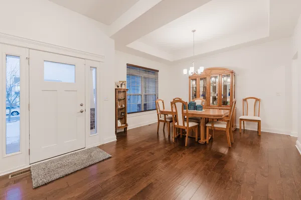 a view of a dining room with furniture and wooden floor