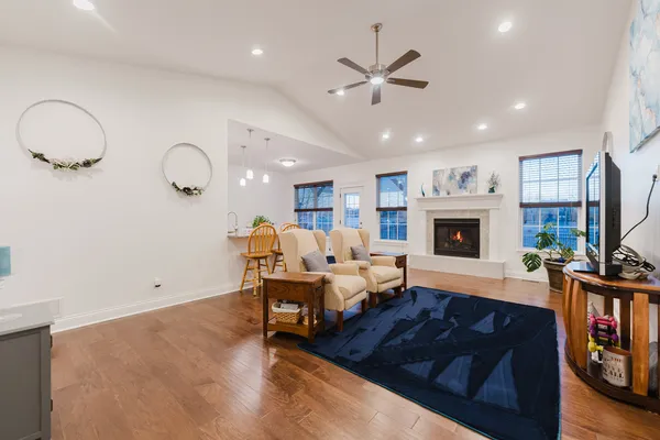 a living room with furniture a fireplace and a flat screen tv